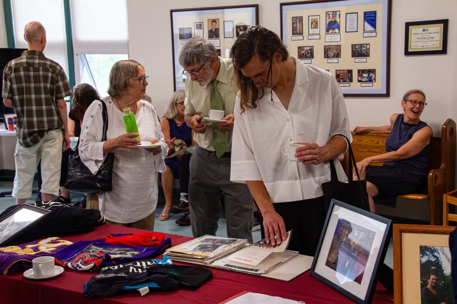 A guest looks through a photo album at the reception